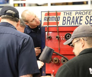 image of students looking at a brake system in shop