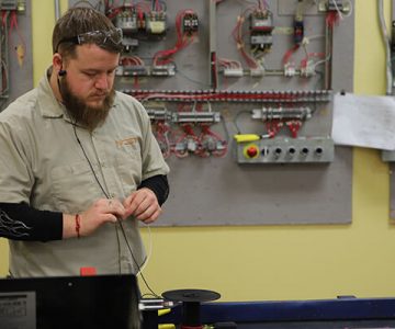 image of electrician student working on wiring