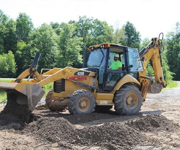image of large excavator working on a dirt road
