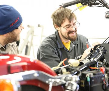 image of students working on a motorcycle