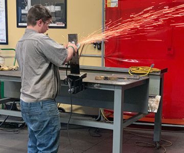 image of student welding with sparks flying