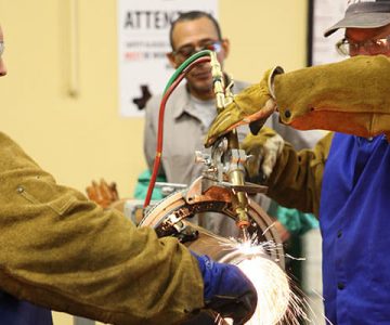 image of students working together welding