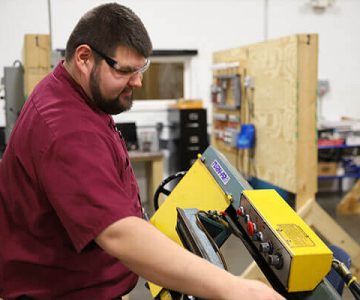 image of student working with machinery