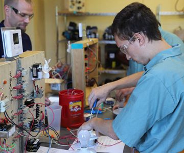 image of HVAC students working on the wiring of a heating control system