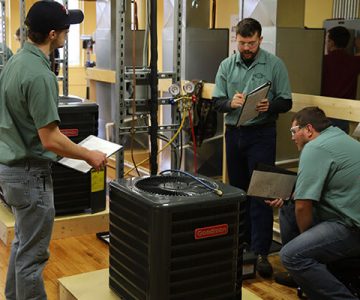 image of students working on an air conditioning unit