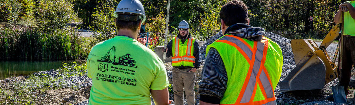 Image of heavy equipment workers in the yard with a forklift