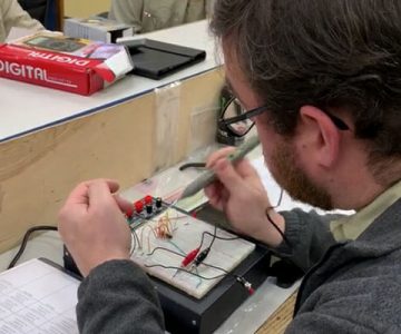 image of electrical student working on a wiring part in classroom