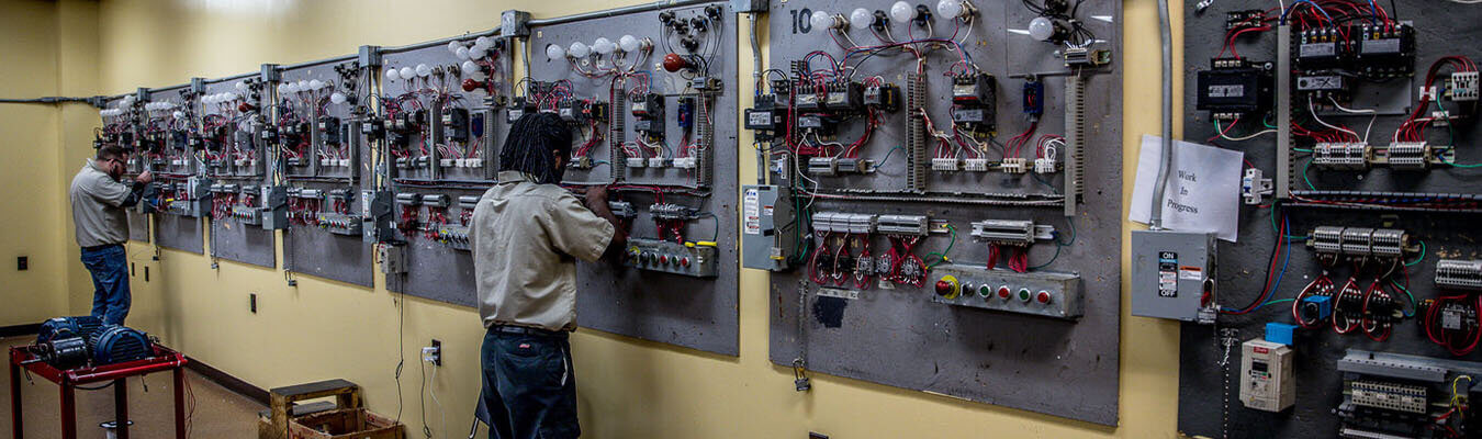 students in the electrical technology lab working on circuit breakers