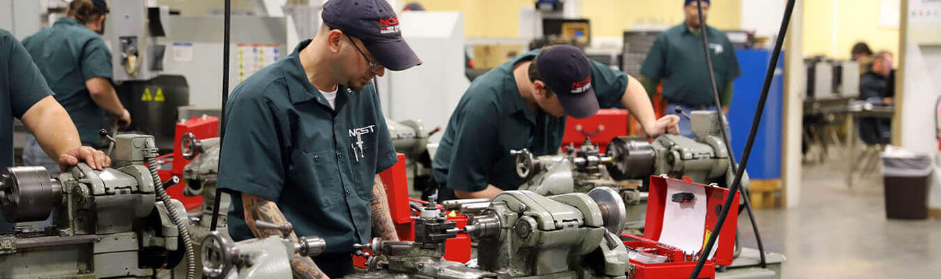 Image of machinist student using instrument for drilling