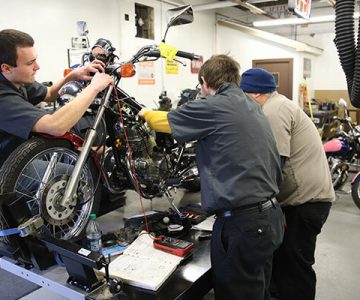 image of students working on motorcycle