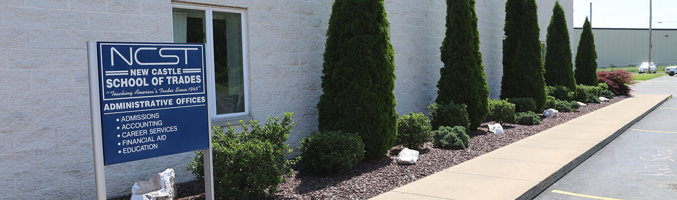 Image of exterior entrance of the New Castle, PA Campus with a welcome sign