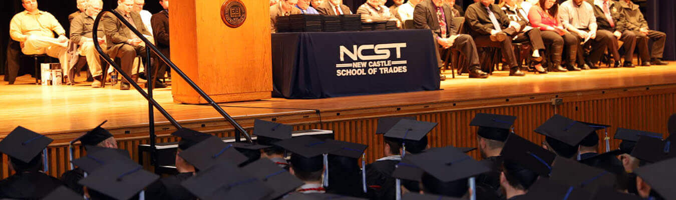 Image of an NCST graduation with students in cap and gowns