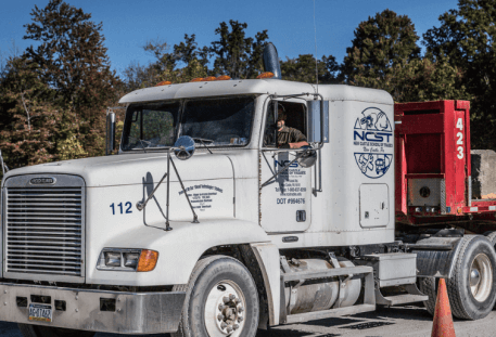 Image of red and white NCST truck.