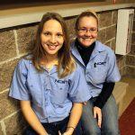 image of two female NCST students smiling while sitting on a bench
