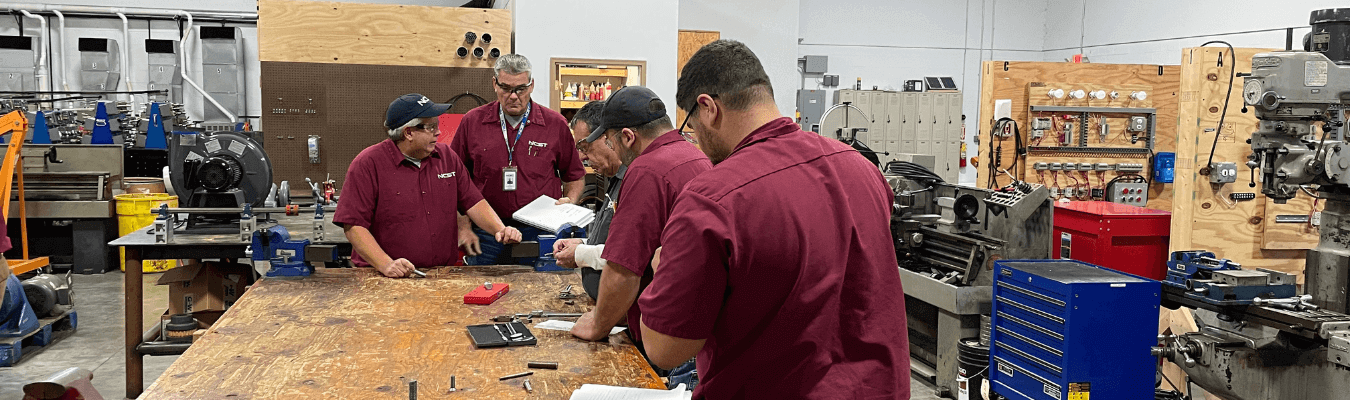 image of a team of IEM students working around table