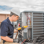 Image of man working on HVAC system outdoors