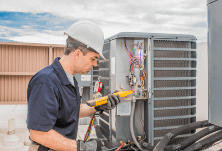 Image of man working on HVAC system outdoors