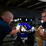 image of two diesel technology students working on a project in the training facility