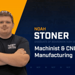 Noah Stoner standing with arms crossed with NCST themed backdrop