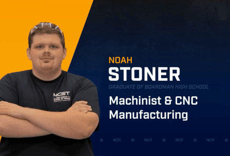 Noah Stoner standing with arms crossed with NCST themed backdrop