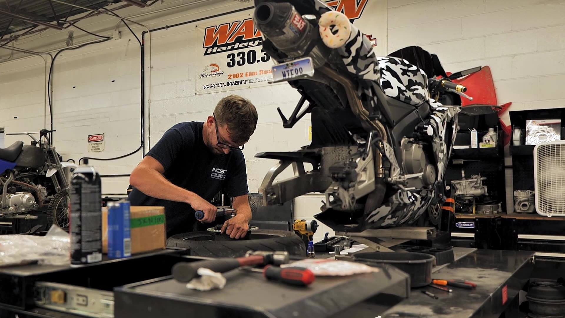 Aaron Dilling working on motorcycle parts
