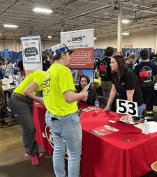 NCST students and employers standing around tables at the career fair