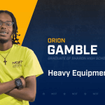 Orion Gamble standing with arms crossed with NCST themed backdrop