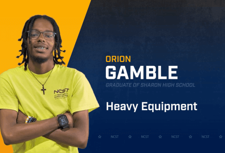 Orion Gamble standing with arms crossed with NCST themed backdrop