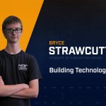 Bryce Strawcutter standing with arms crossed with NCST themed backdrop