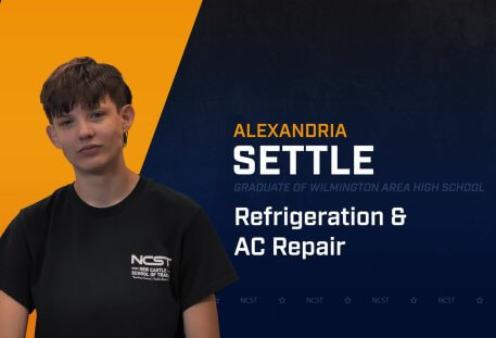 Alexandria Settle standing with arms crossed with NCST themed backdrop