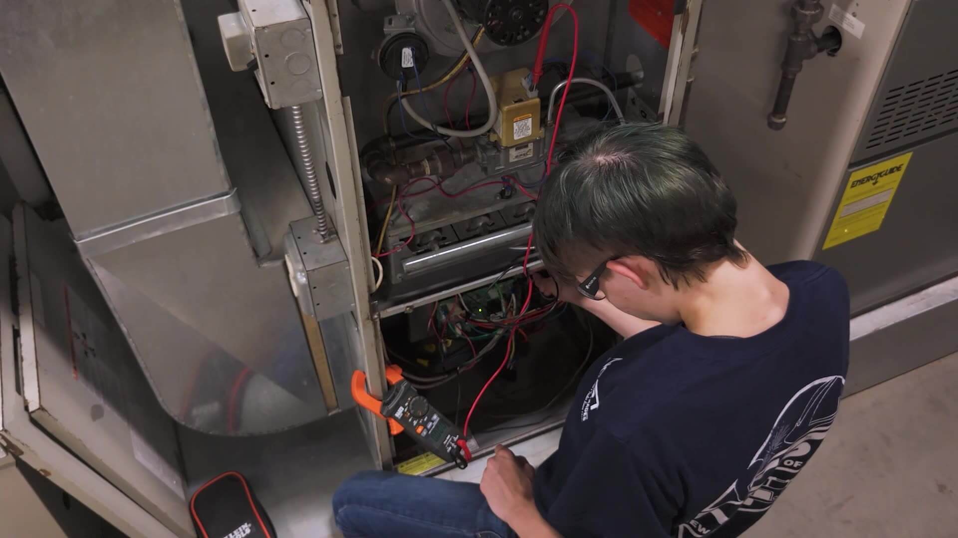 Overhead shot of Alexandria working on a HVAC system