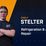 Emily Stelter standing with arms crossed with NCST themed backdrop