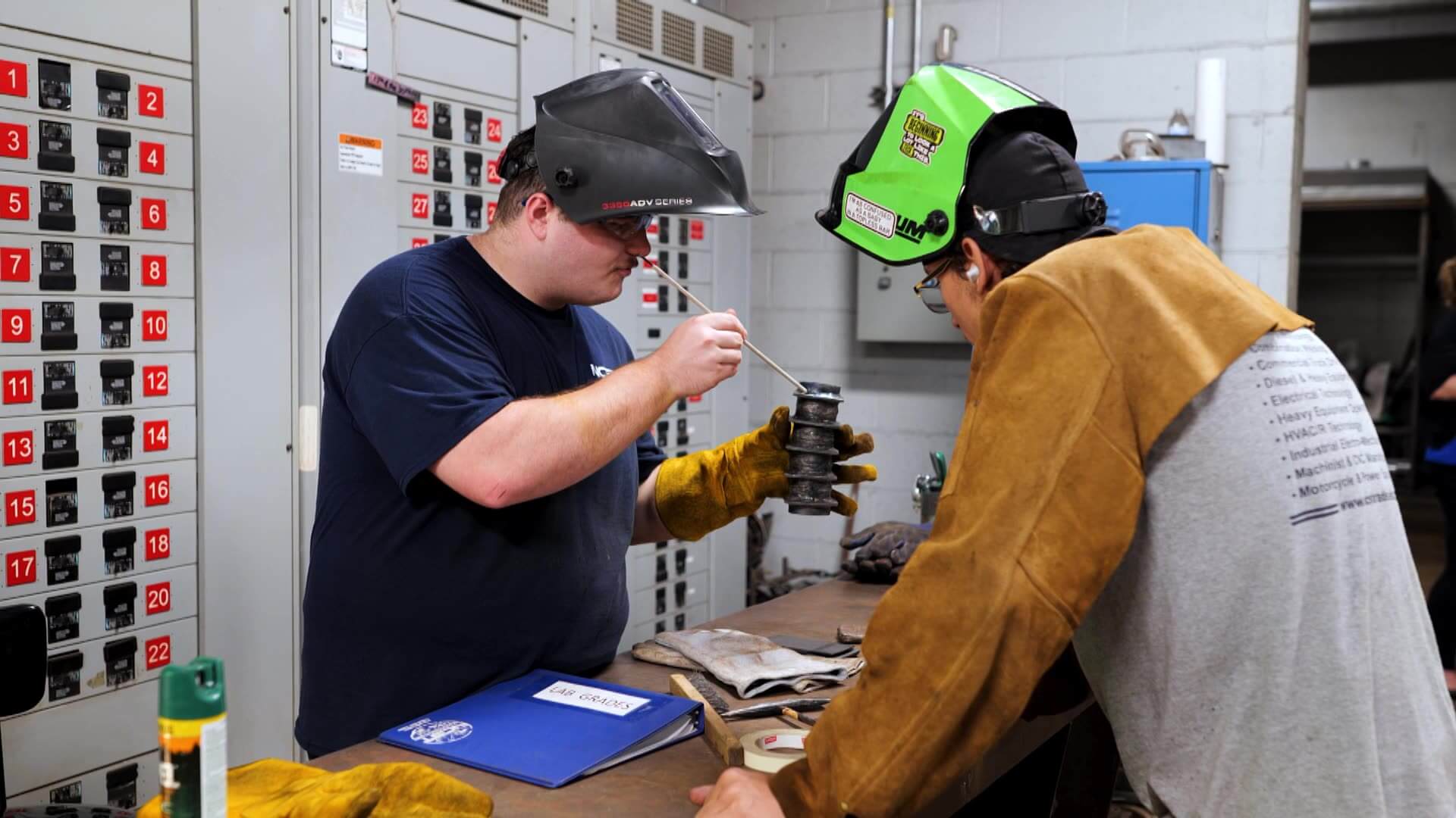 Alex and Sebastian working on a welding project at a table