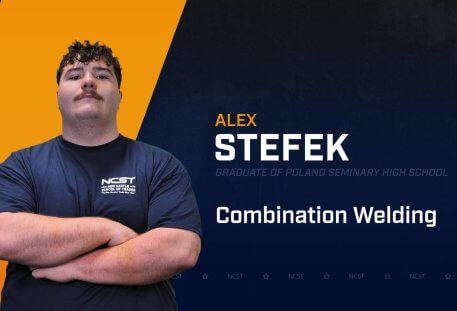 Alex Stefek standing with arms crossed with NCST themed backdrop