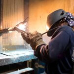 NCST student welding with welding mask on