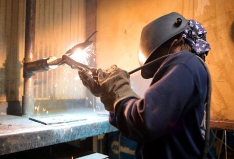 NCST student welding with welding mask on
