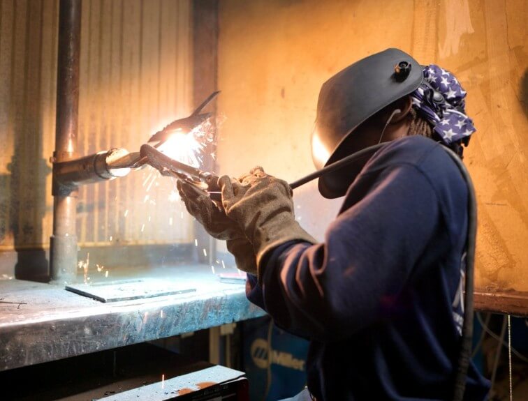 NCST student welding with welding mask on
